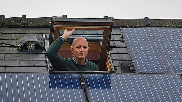 Max wilkinson looking at solar panels via a skylight